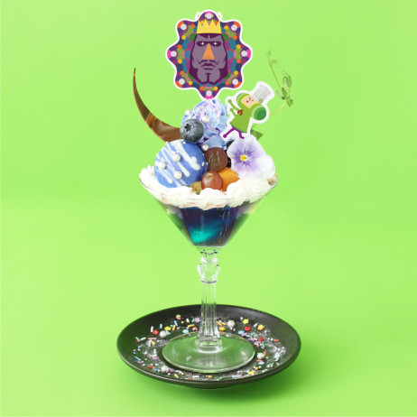 A blue-themed parfait with a paper cutout of the Prince and the King of All Cosmos on top.