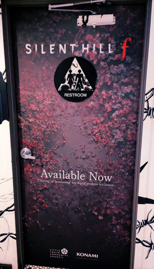 Silent Hill f logo decal on a bathroom door