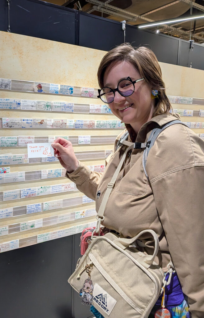 Me holding up my fan comment card to put up on the fan comment wall