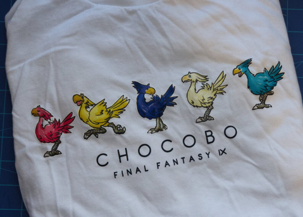 Close-up of a FFIX chocobo shirt featuring chocobo illustrations in a row of different colors