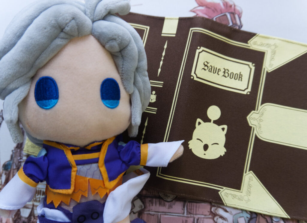 Kuja plushie closeup. He is pointing to the Moogle Save Book.
